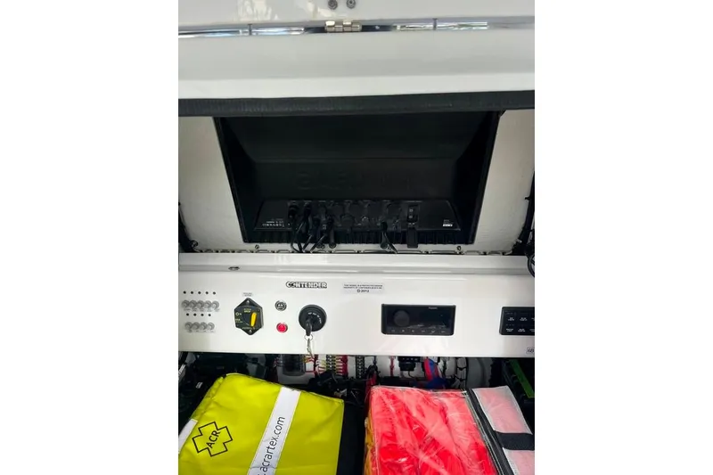 Slide: The Image of Control panel of 2025 Contender 26 Bay boat with safety equipment visible. - 13