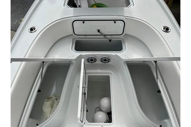 Slide: The Image of 2025 Contender 26 Bay boat interior with storage compartments and speakers. - 15