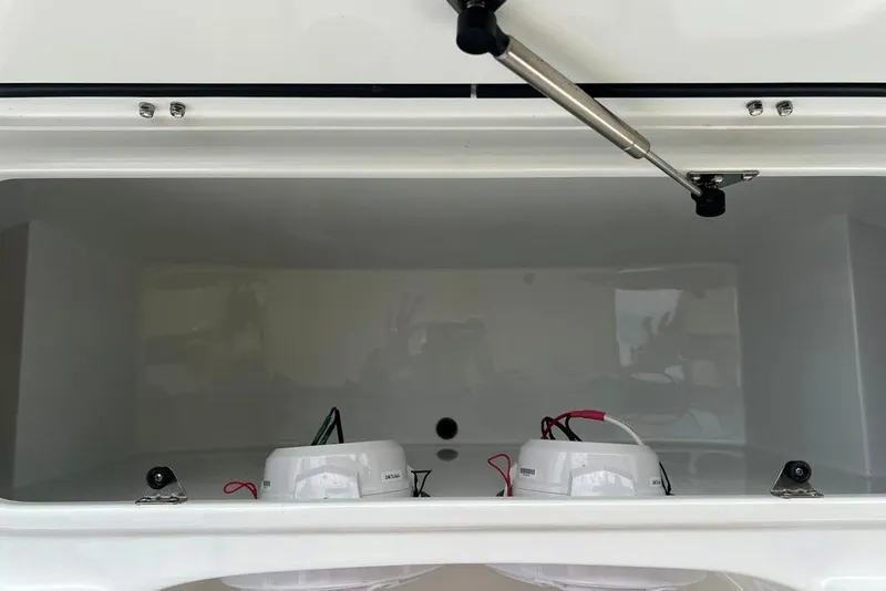 Slide: The Image of Open storage compartment in 2025 Contender 26 Bay boat, featuring hydraulic support. - 16