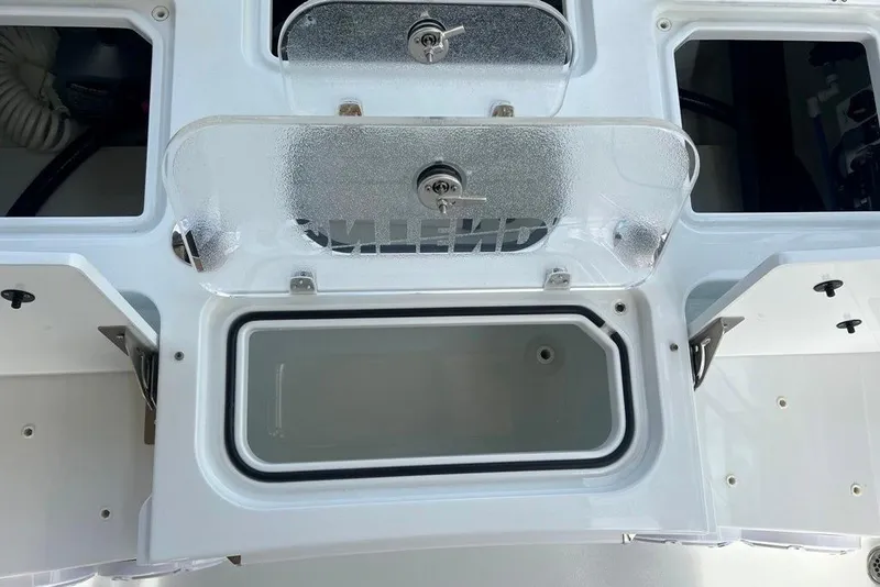 Slide: The Image of 2025 Contender 26 Bay boat storage compartments with clear lids and secure locks. - 17