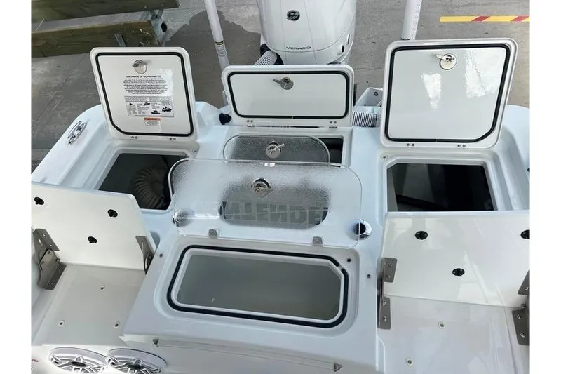 Slide: The Image of 2025 Contender 26 Bay boat with open storage compartments and Verado engine. - 18