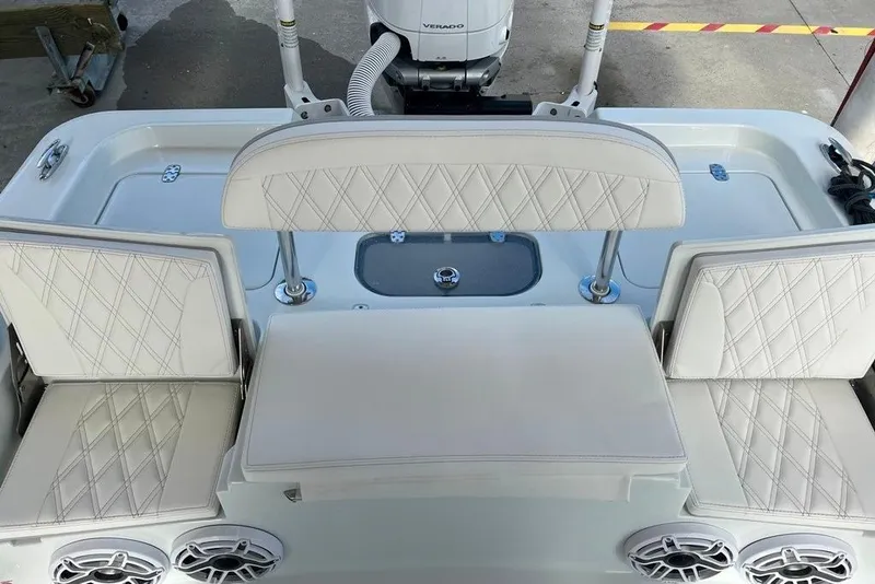Slide: The Image of 2025 Contender 26 Bay boat interior with white cushioned seating and speakers. - 19