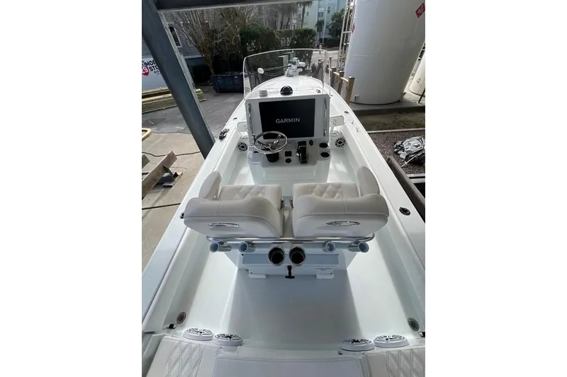 Slide: The Image of 2025 Contender 26 Bay boat interior with Garmin navigation system and dual seating. - 2