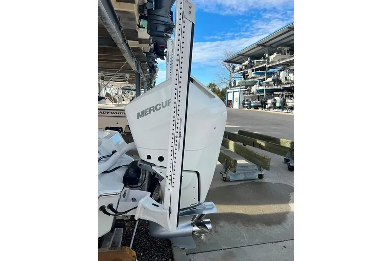 Slide: The Image of Contender 26 Bay 2025 with Mercury outboard motor in storage facility. - 21