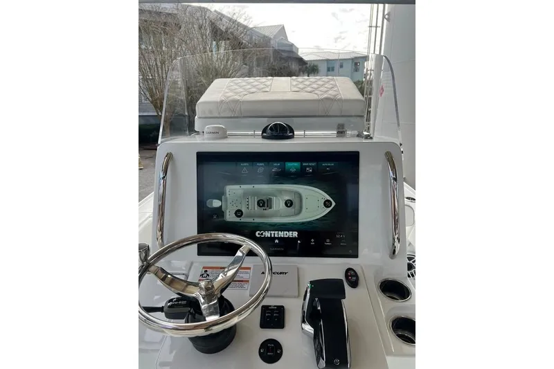 Slide: The Image of 2025 Contender 26 Bay boat dashboard with steering wheel and digital display. - 3
