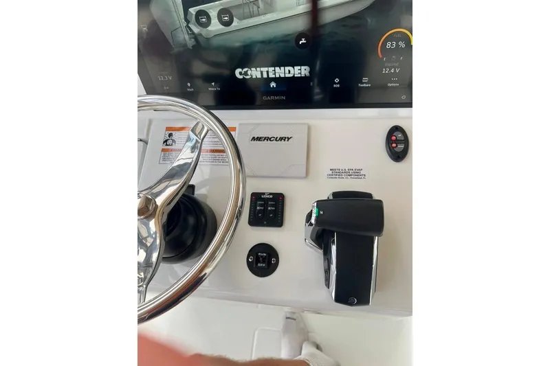 Slide: The Image of 2025 Contender 26 Bay boat dashboard with steering wheel and control panel. - 7