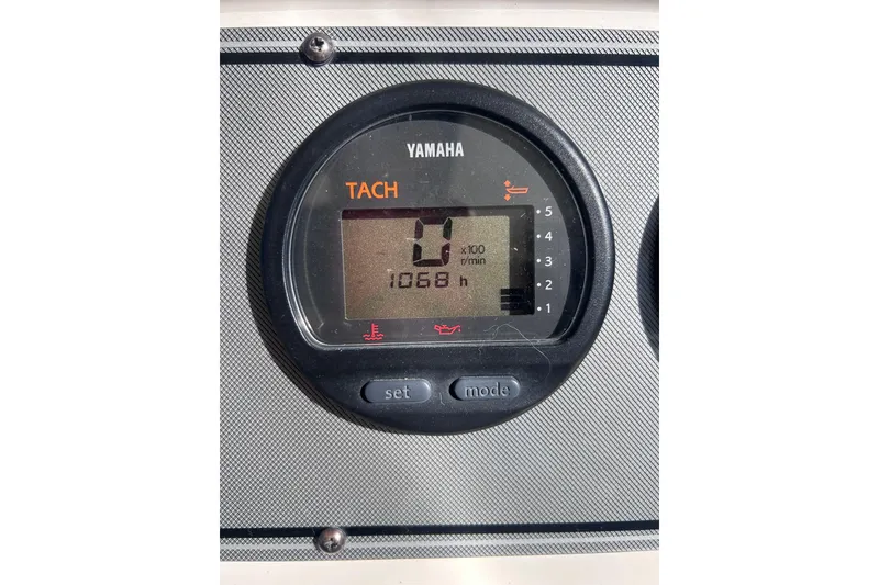 Slide: The Image of Yamaha tachometer displaying 1068 hours on a 2006 Wellcraft 290 Coastal boat. - 12