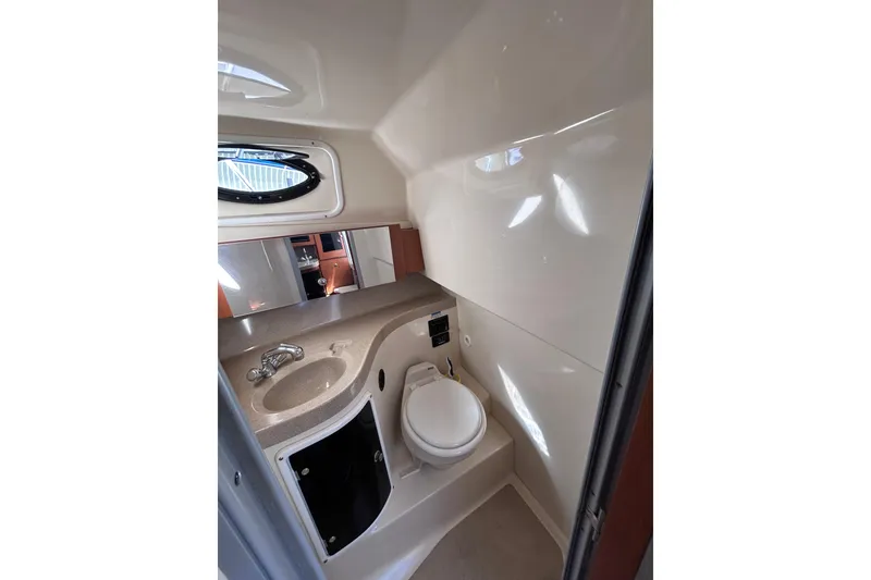 Slide: The Image of 2006 Wellcraft 290 Coastal boat bathroom with sink, toilet, and mirror. - 18