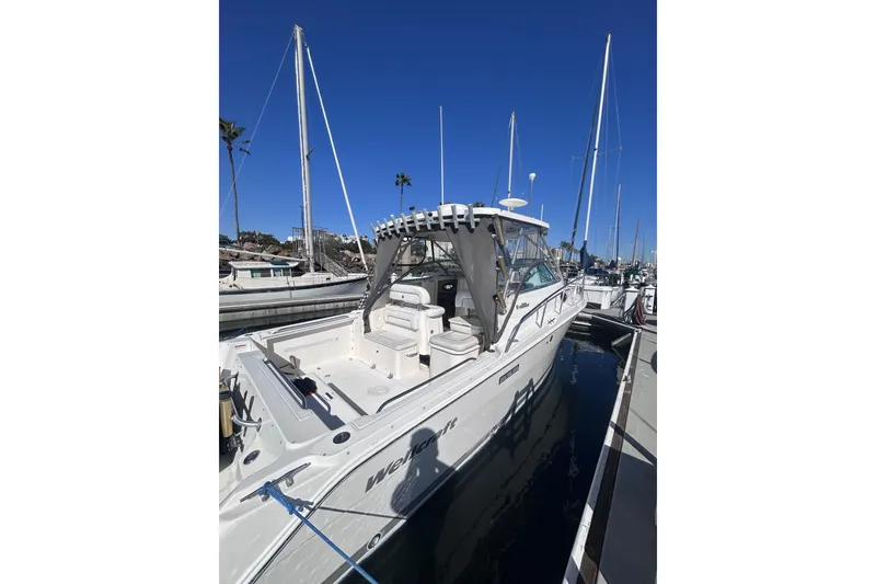 Slide: The Image of 2006 Wellcraft 290 Coastal boat docked at marina under clear blue sky. - 22