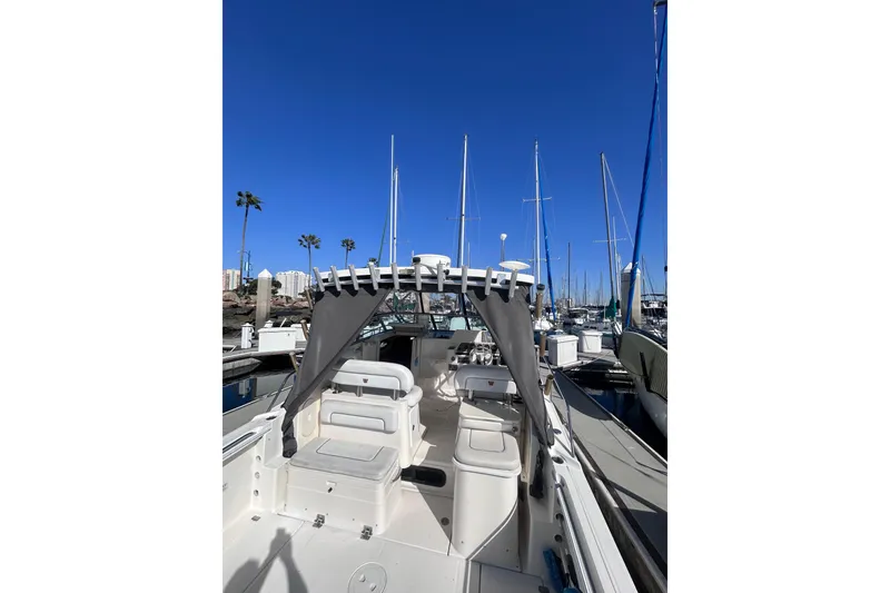 Slide: The Image of 2006 Wellcraft 290 Coastal boat docked at marina under clear blue sky. - 32