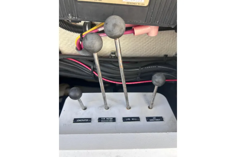 Slide: The Image of Control levers on a 2006 Wellcraft 290 Coastal boat dashboard. - 35