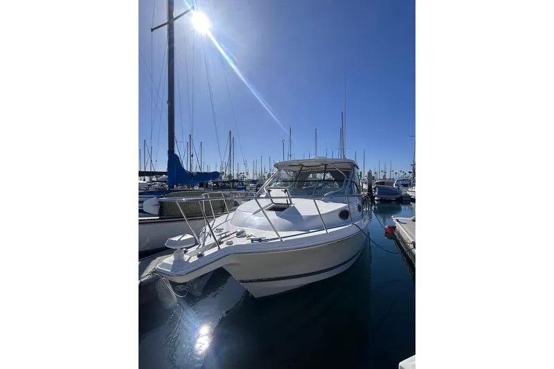 Slide: The Image of 2006 Wellcraft 290 Coastal boat docked in a sunny marina. - 8