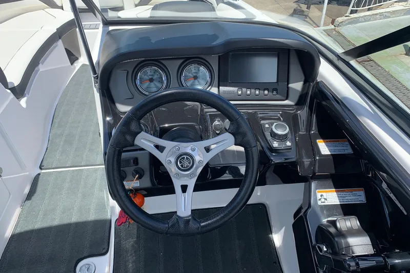 Slide: The Image of 2016 Yamaha Boats 242 Limited dashboard with steering wheel and control panel. - 5