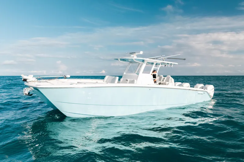 The Image of 2021 Invincible 37 Catamaran cruising on open ocean under clear blue sky. - 1