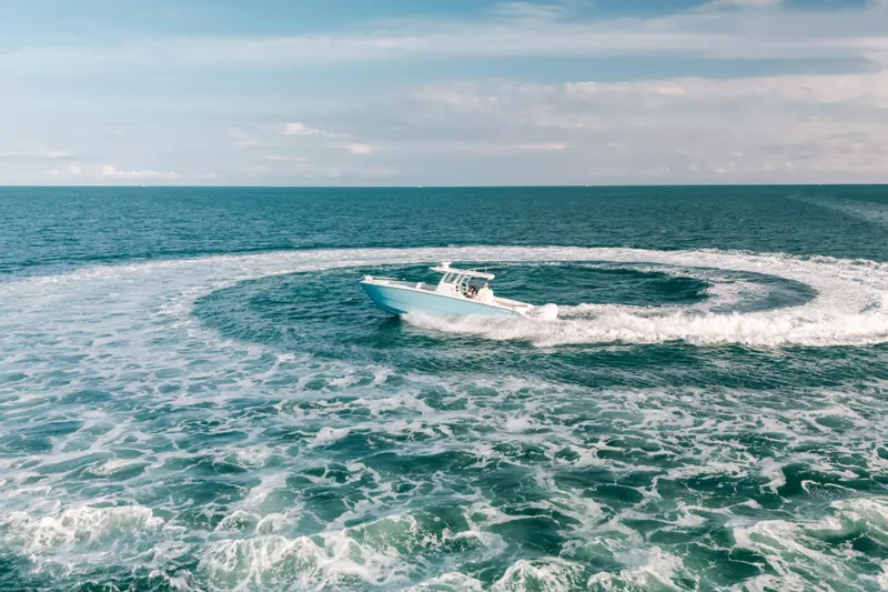 Slide: The Image of Invincible 37 Catamaran 2021 making waves in open ocean, aerial view. - 11