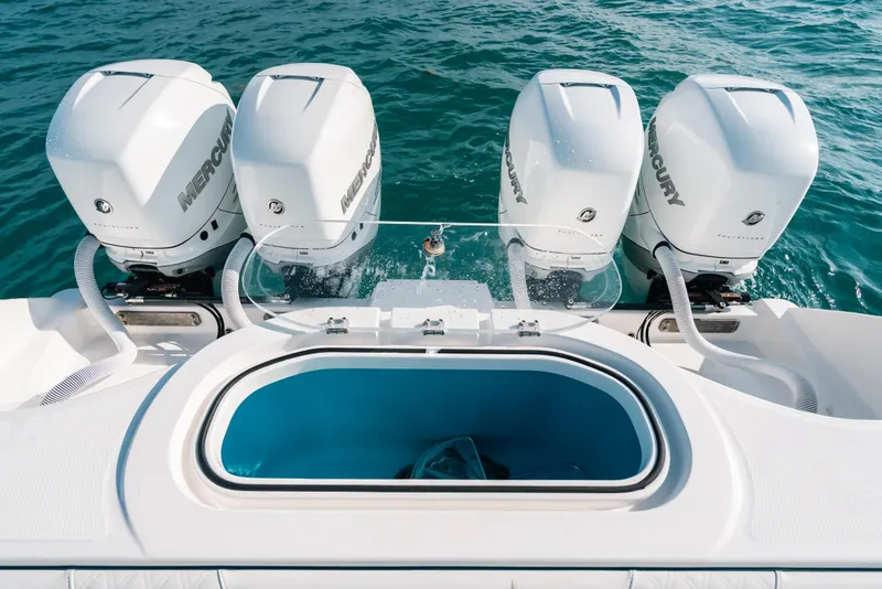 Slide: The Image of 2021 Invincible 37 Catamaran with four Mercury outboard engines on blue water. - 23