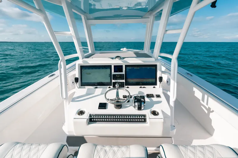 Slide: The Image of 2021 Invincible 37 Catamaran helm with dual screens on open ocean. - 26