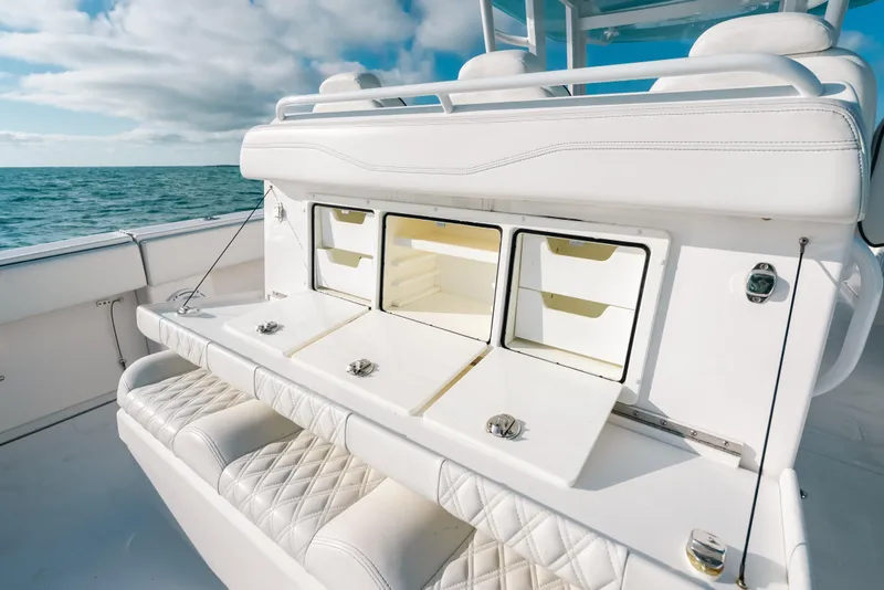 Slide: The Image of 2021 Invincible 37 Catamaran interior with white seating and storage compartments, ocean view. - 31