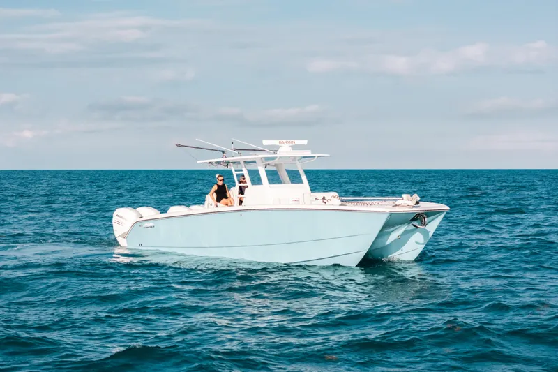 Slide: The Image of 2021 Invincible 37 Catamaran cruising on open sea under clear skies. - 4