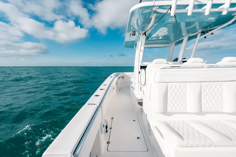 Slide: The Image of Invincible 37 Catamaran 2021 cruising on open ocean under clear blue sky. - 41