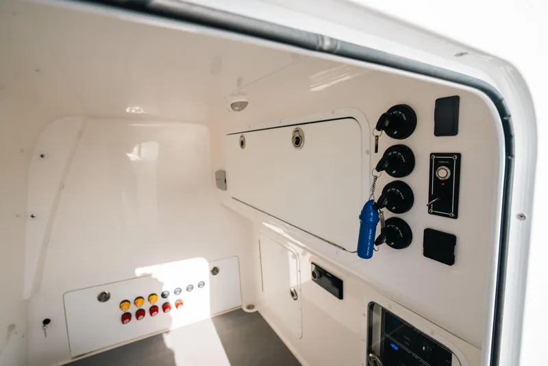 Slide: The Image of Interior view of 2021 Invincible 37 Catamaran control panel with switches and keys. - 43