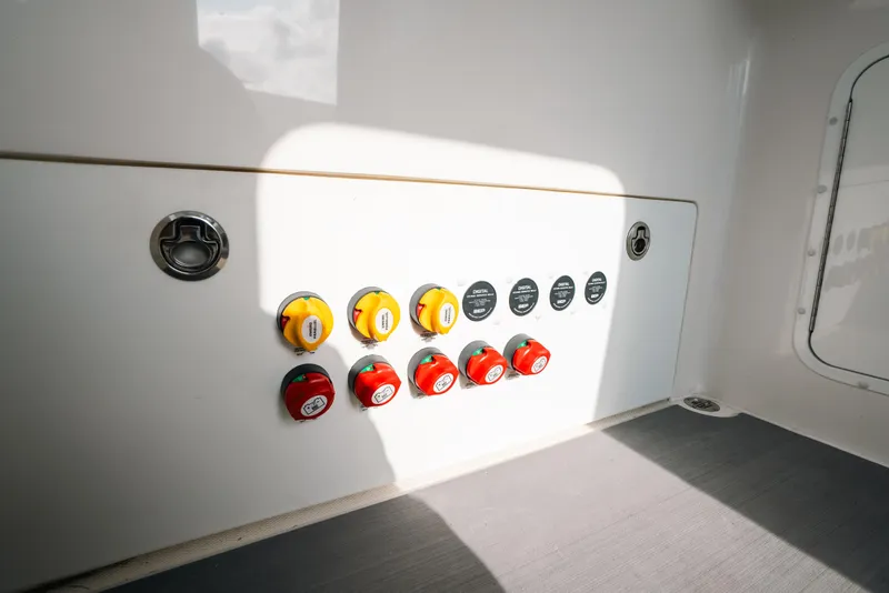 Slide: The Image of Control panel of 2021 Invincible 37 Catamaran with switches and dials. - 45