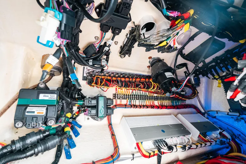 Slide: The Image of Electrical wiring system inside a 2021 Invincible 37 Catamaran, showcasing organized cables and components. - 47