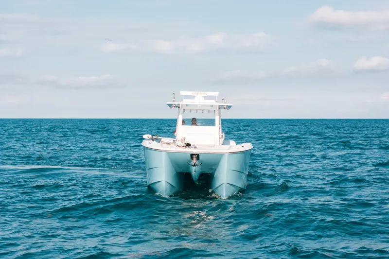 Slide: The Image of Invincible 37 Catamaran 2021 cruising on open ocean under clear sky. - 5