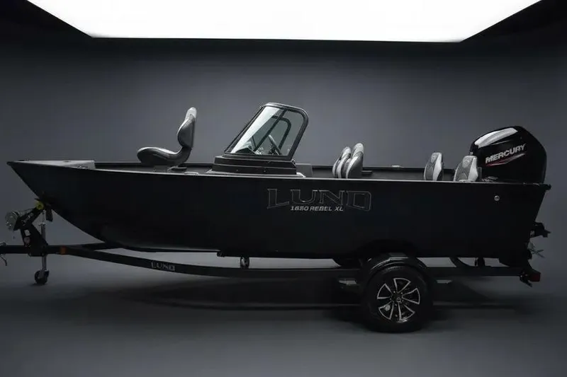 The Image of 2026 Lund 1650 Rebel XL Sport boat on trailer, side view in studio setting. - 0