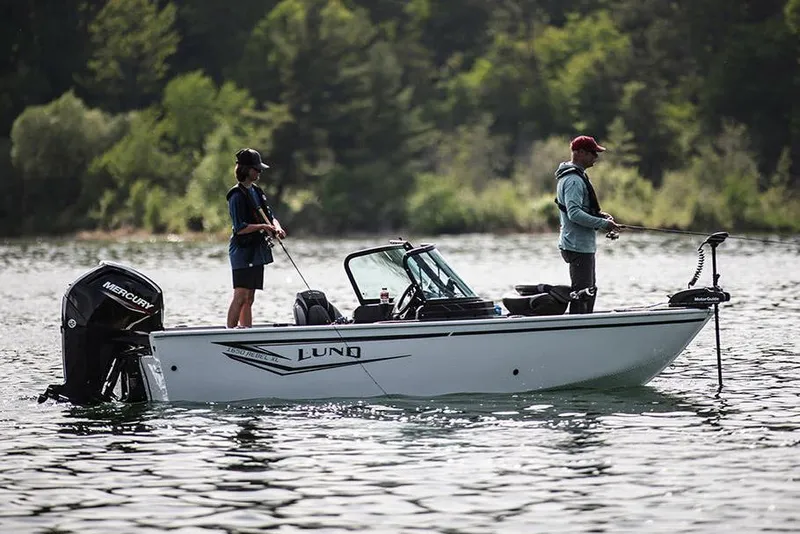 Slide: The Image of Manufacturer Provided Image: 2025 Lund 1650 Rebel XL Sport boat on a lake with two people fishing. - 2
