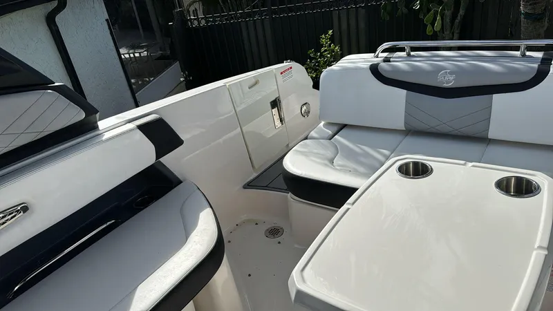 Slide: The Image of 2021 Chaparral 30 Surf boat interior with seating and cup holders. - 2