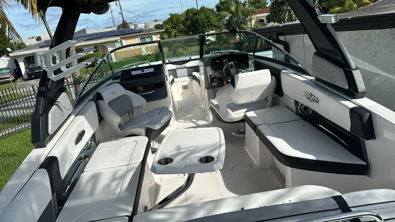 Slide: The Image of 2021 Chaparral 30 Surf boat interior with white seating and modern dashboard. - 5