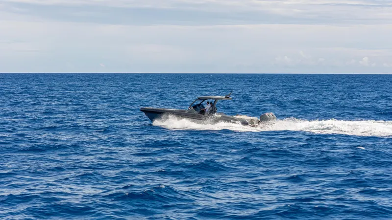 Slide: The Image of 2025 Skipper-BSK 38 boat cruising on open ocean waters. - 21