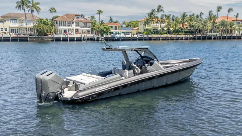 Slide: The Image of 2025 Skipper-BSK 38 boat on water near luxury waterfront homes. - 37