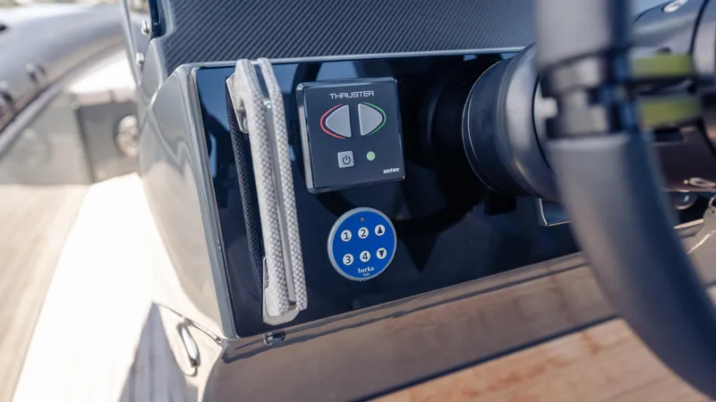Slide: The Image of Control panel of 2025 Skipper-BSK 38 boat, featuring thruster and steering wheel. - 47