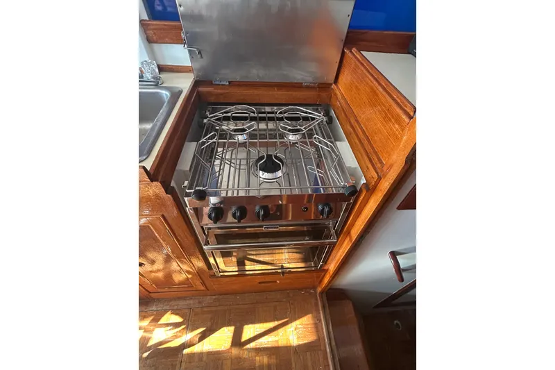 Slide: The Image of Interior of a 1973 Grand Banks 32 Sedan boat with wooden finishes and nautical decor. - 12