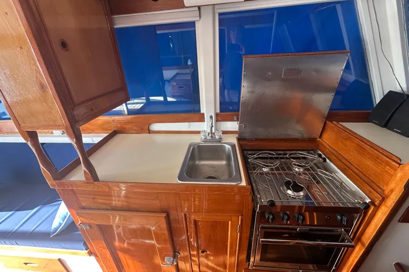 Slide: The Image of 1973 Grand Banks 32 Sedan helm with wooden wheel and navigation instruments. - 17