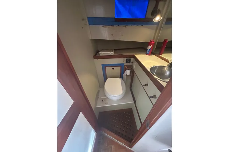 Slide: The Image of 1973 Grand Banks 32 Sedan kitchen with wooden cabinetry and stainless steel oven. - 20