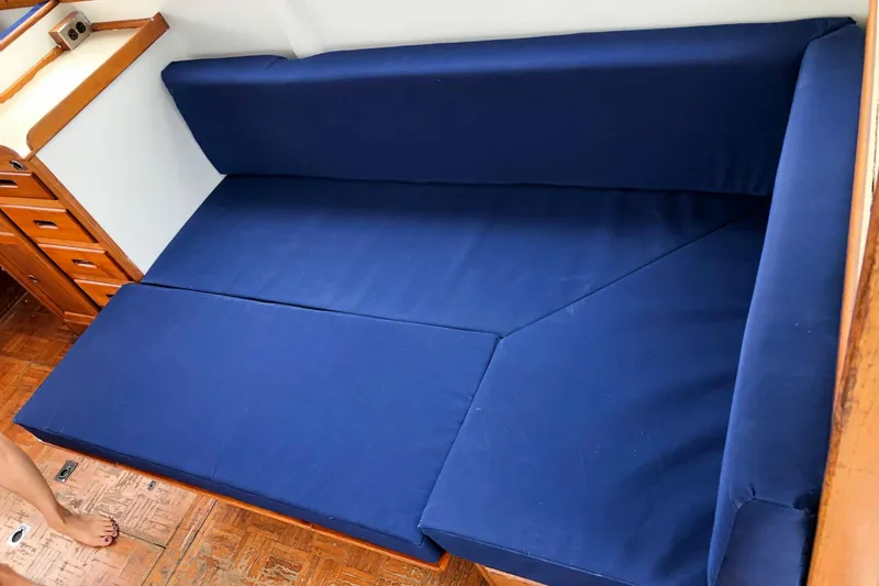 Slide: The Image of Blue cushioned seating area inside a 1973 Grand Banks 32 Sedan boat. - 31