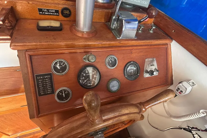 Slide: The Image of 1973 Grand Banks 32 Sedan with striped seating, docked in a marina. - 4