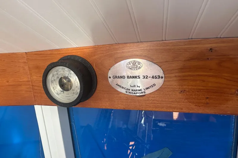 Slide: The Image of Interior of a 1973 Grand Banks 32 Sedan boat with wooden cabinetry and blue seating. - 9