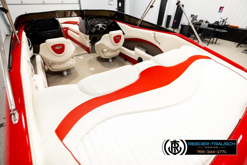 Slide: The Image of 2005 Crownline 225 LPX boat interior with red and white seating, steering wheel, and dashboard. - 11