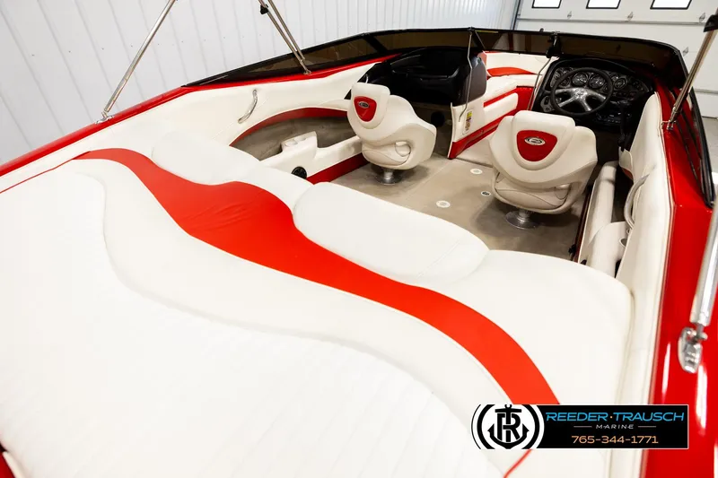 Slide: The Image of 2005 Crownline 225 LPX boat interior with red and white seating, steering wheel, and dashboard. - 12