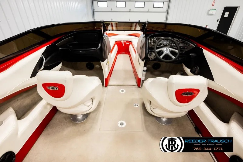 Slide: The Image of 2005 Crownline 225 LPX boat interior with red and white seating, steering wheel, and dashboard. - 14