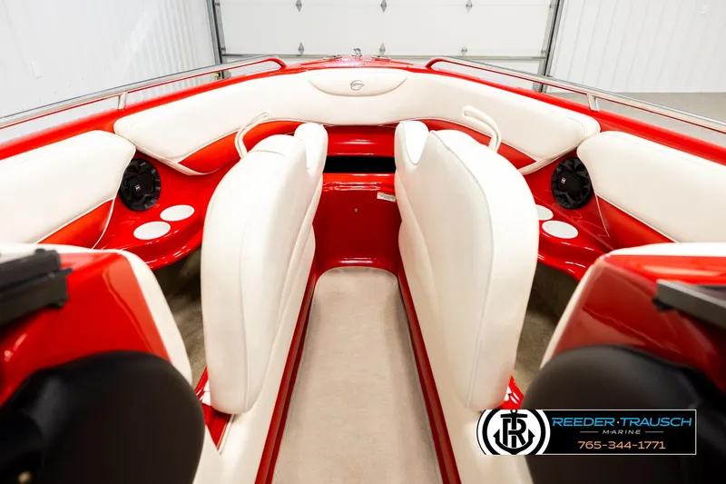Slide: The Image of 2005 Crownline 225 LPX boat interior with red and white seating, speakers, and cup holders. - 16