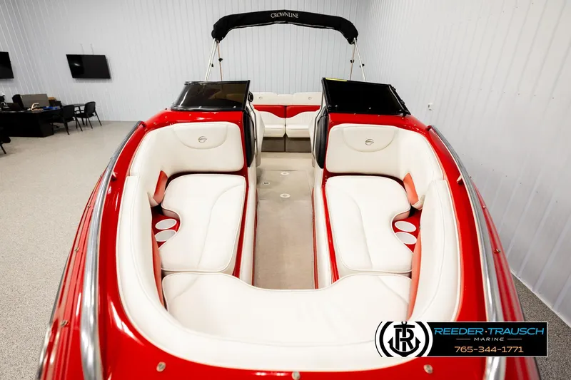 Slide: The Image of 2005 Crownline 225 LPX boat with red and white interior, displayed indoors. - 17