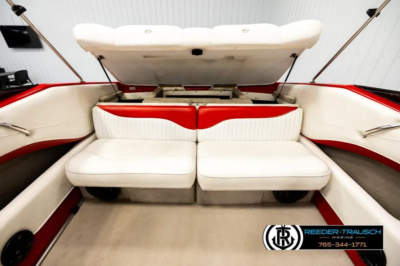 Slide: The Image of 2005 Crownline 225 LPX boat interior with white and red seating, open storage compartment. - 20