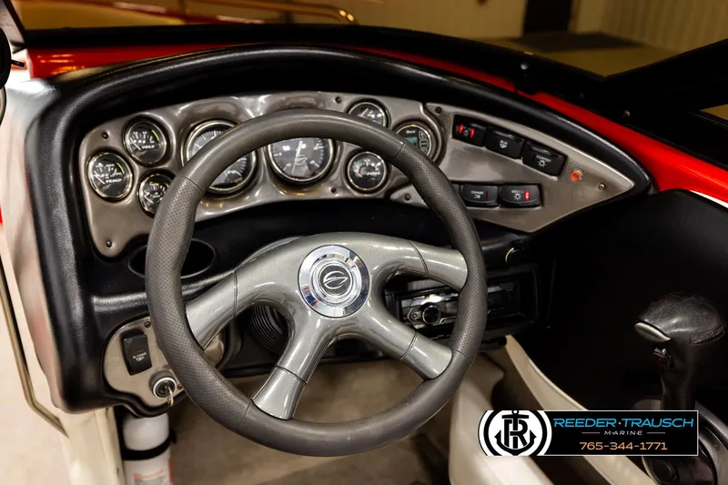 Slide: The Image of 2005 Crownline 225 LPX boat dashboard with steering wheel and control gauges. - 24