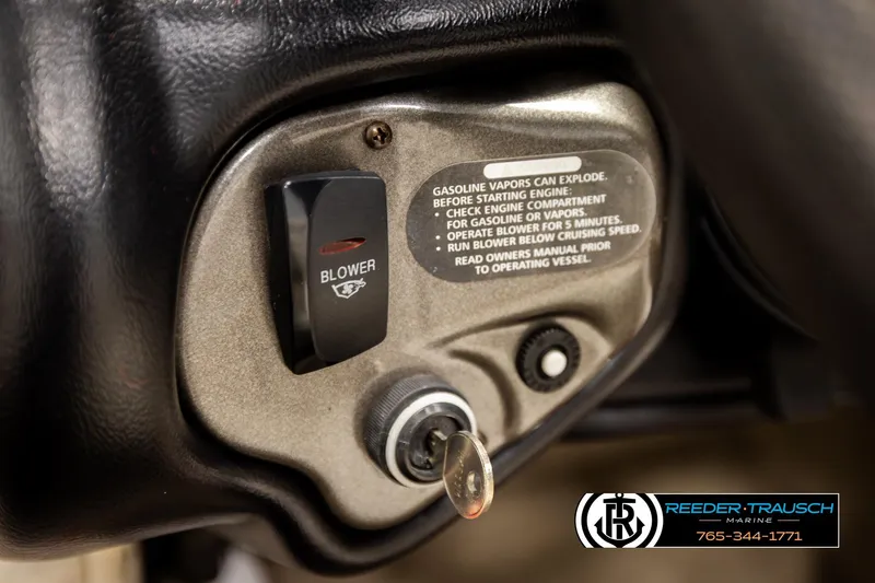 Slide: The Image of 2005 Crownline 225 LPX boat ignition and blower switch with safety warning label. - 26
