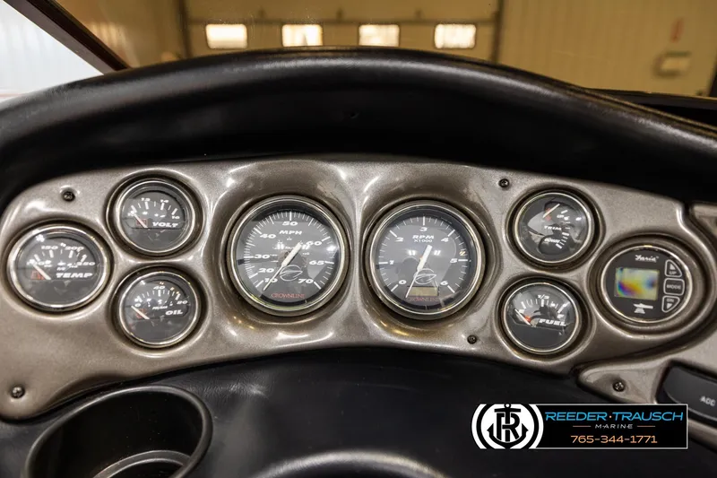 Slide: The Image of Dashboard of a 2005 Crownline 225 LPX boat with various gauges and controls. - 27